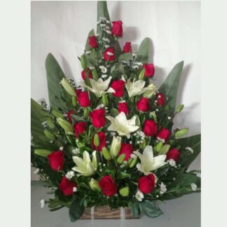 Funeral arrangement of red roses and lilies
